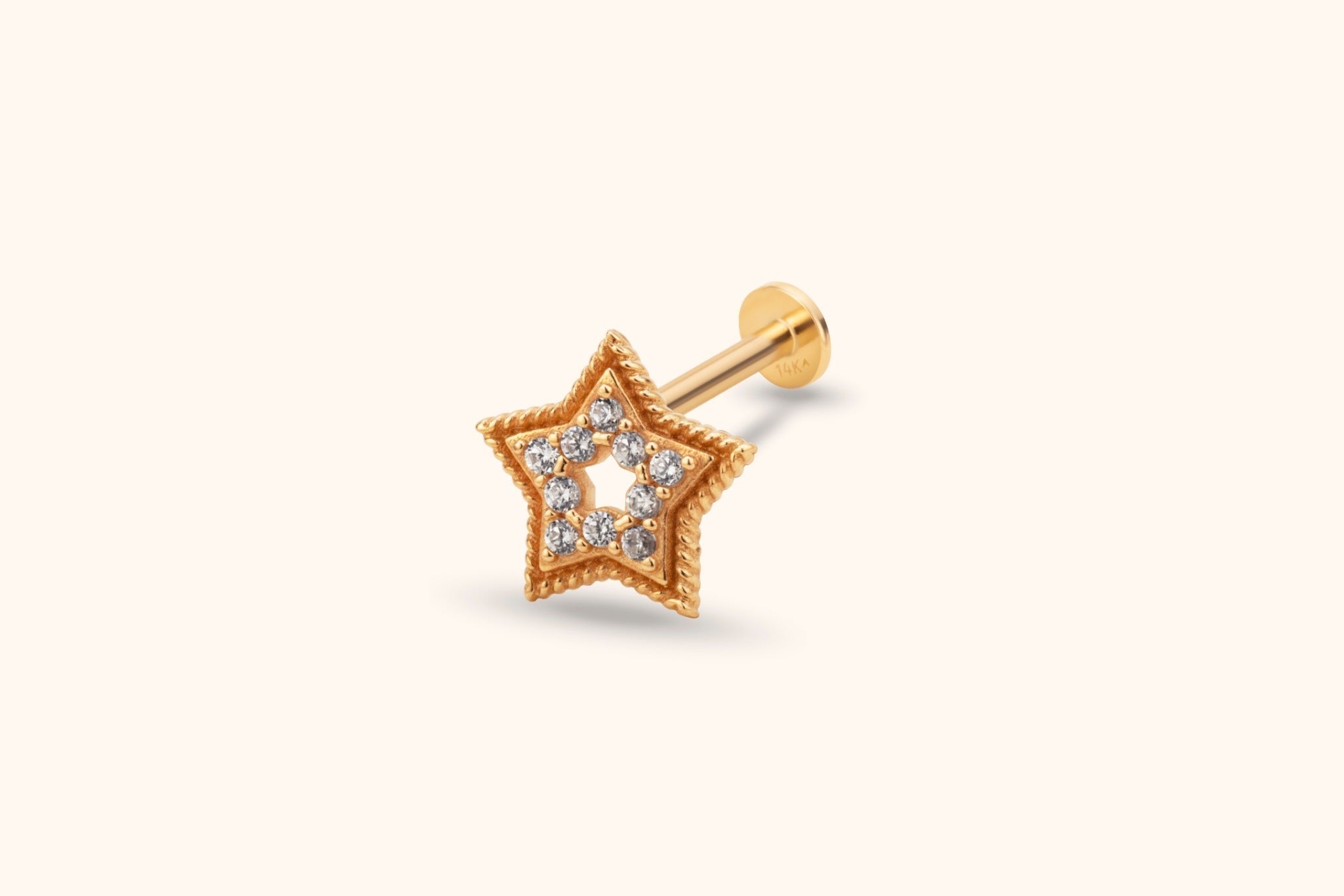 Gold-toned star stud with an open center, clear round accents, a twisted border, and a straight post with a flat disc back.