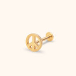 Gold-tone peace sign stud earring with a straight post and flat round back, shown at an angle on a pale cream background.