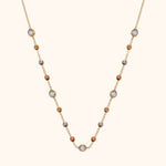 Gold-tone chain necklace with gold-, silver- and copper-tone beads and five round, silver-colored faceted accents.