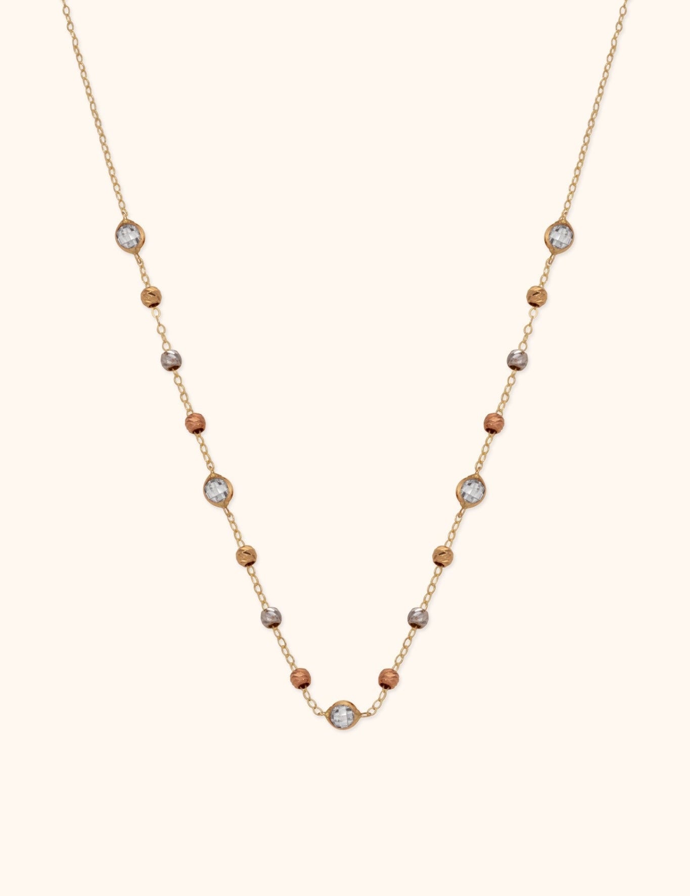 Gold-tone chain necklace with gold-, silver- and copper-tone beads and five round, silver-colored faceted accents.