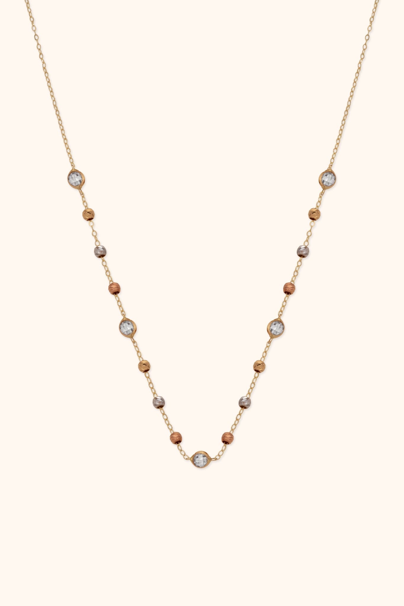 Gold-tone chain necklace with gold-, silver- and copper-tone beads and five round, silver-colored faceted accents.