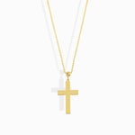 Gold-colored necklace with an oval-link chain, a textured bead, and a smooth, flat cross pendant on a white background.