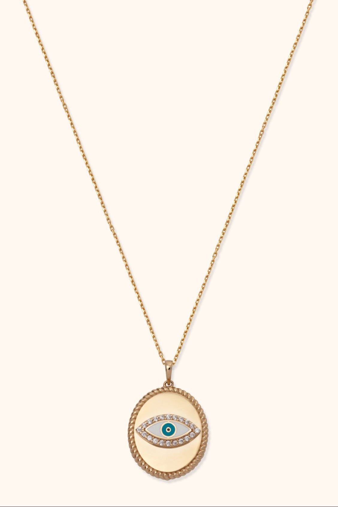 Gold-tone chain necklace with an oval pendant, rope-style border and teal-centered eye motif outlined in clear sparkling accents.