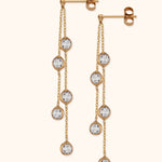 Pair of gold-tone drop earrings, each with two fine chains, five round clear faceted charms, and butterfly backs.