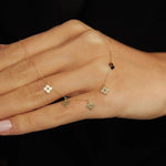 14K gold necklace featuring multiple four-leaf clover charms,