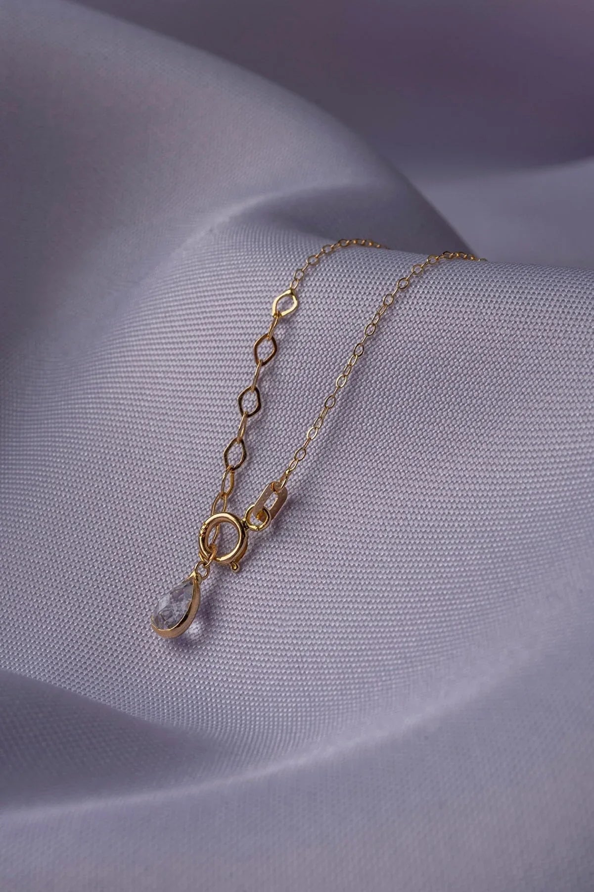 14K gold necklace featuring multiple four-leaf clover charms,