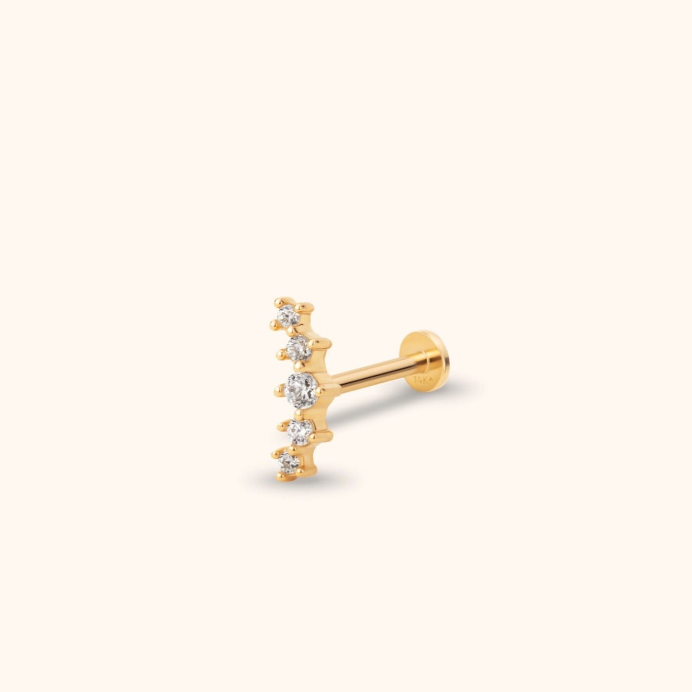 Gold-toned stud earring with five round clear stones in a curved row, a straight post and a flat circular back.
