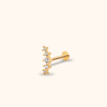 Gold-toned stud earring with five round clear stones in a curved row, a straight post and a flat circular back.