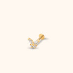 Gold-tone butterfly stud earring with four clear stones, a straight post and a flat round back on a pale cream background.