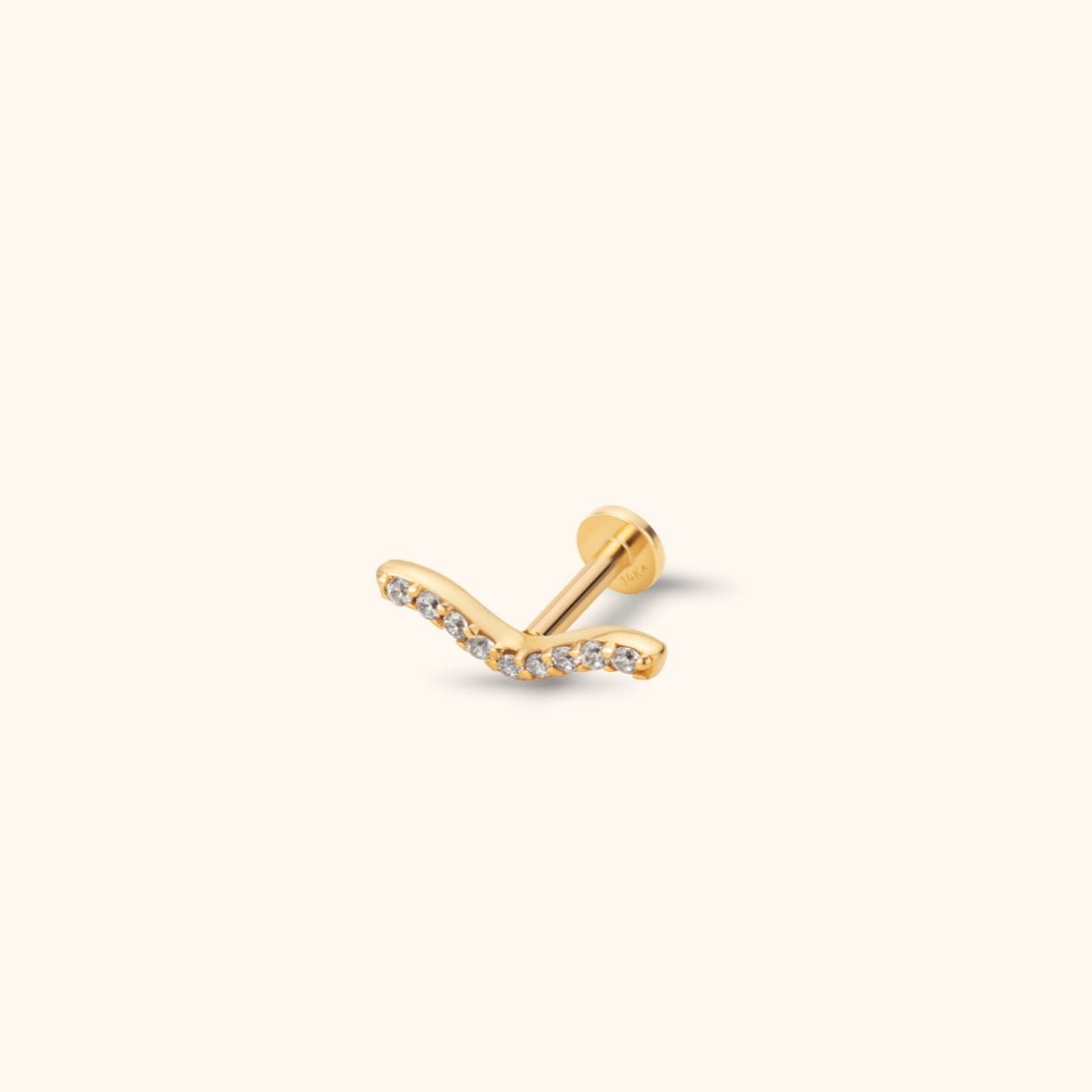 Gold-tone stud earring with a wave-shaped front lined with clear round stones, a straight post and a flat circular back.
