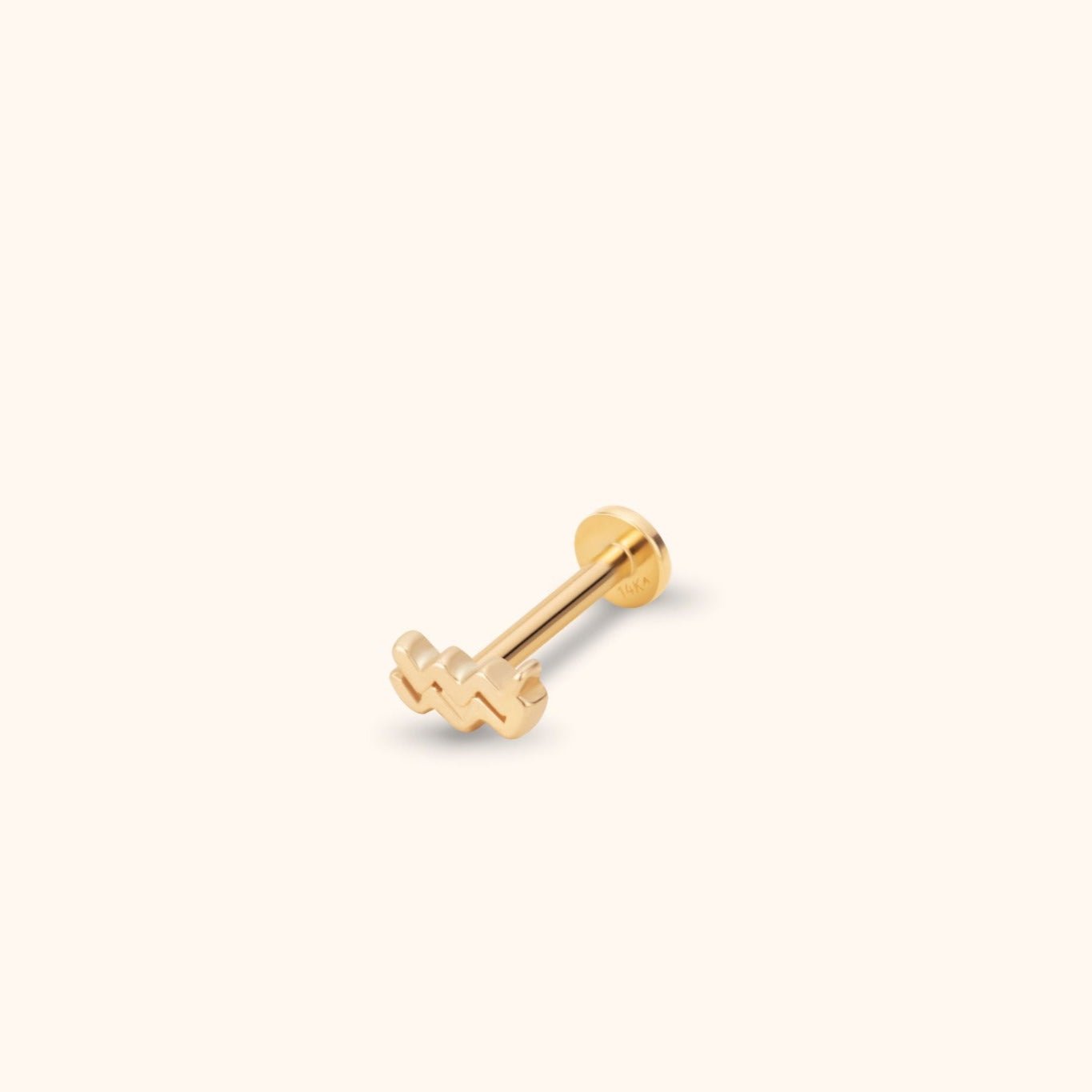Gold-colored Aquarius symbol stud with a straight post and round flat back, shown diagonally on a cream background.