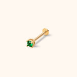 Gold-toned stud with a round green faceted center in a prong setting, a straight post and a flat circular back on a cream background.