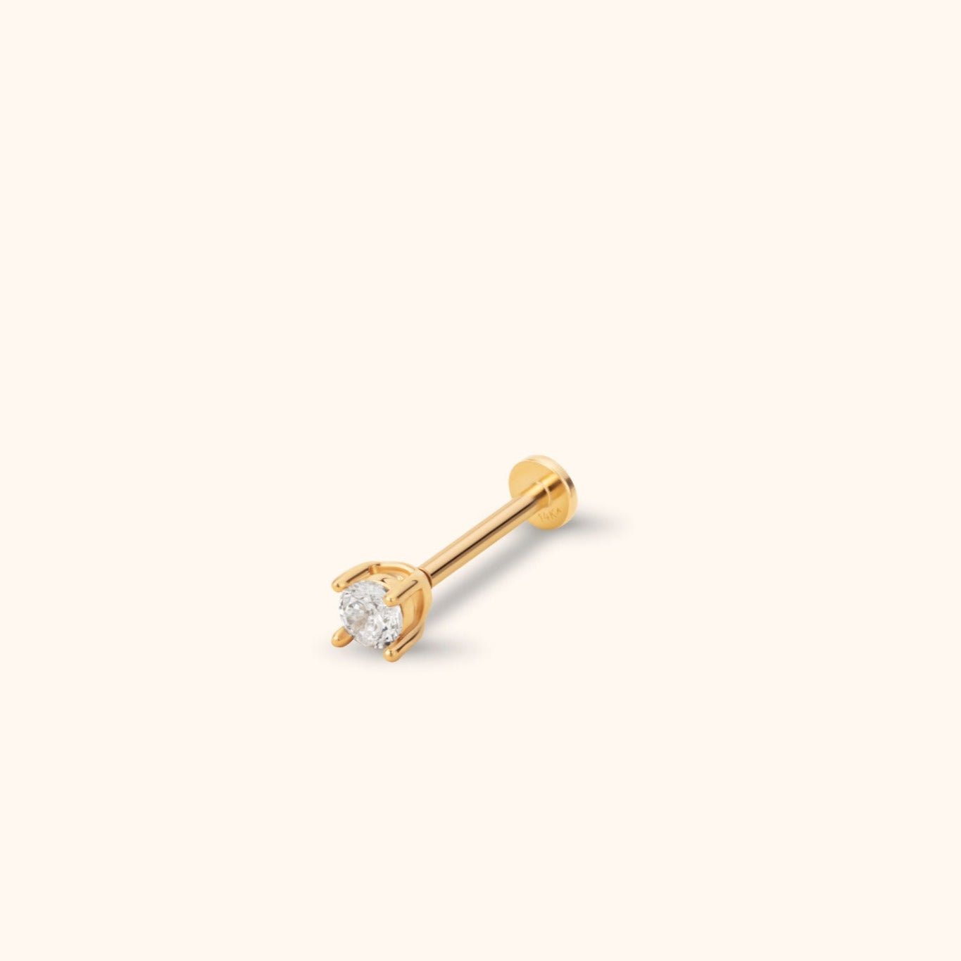 Gold-toned stud with a round, clear faceted centerpiece in a prong setting, a straight post and a flat circular back.