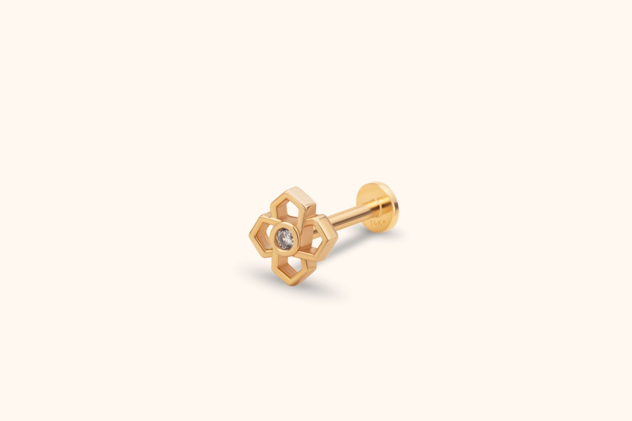model wearing geometric quatrefoil 14k gold tragus/helix cartilage stud