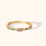 14K gold band with emerald baguette and diamond pavé accents in geometric art deco style