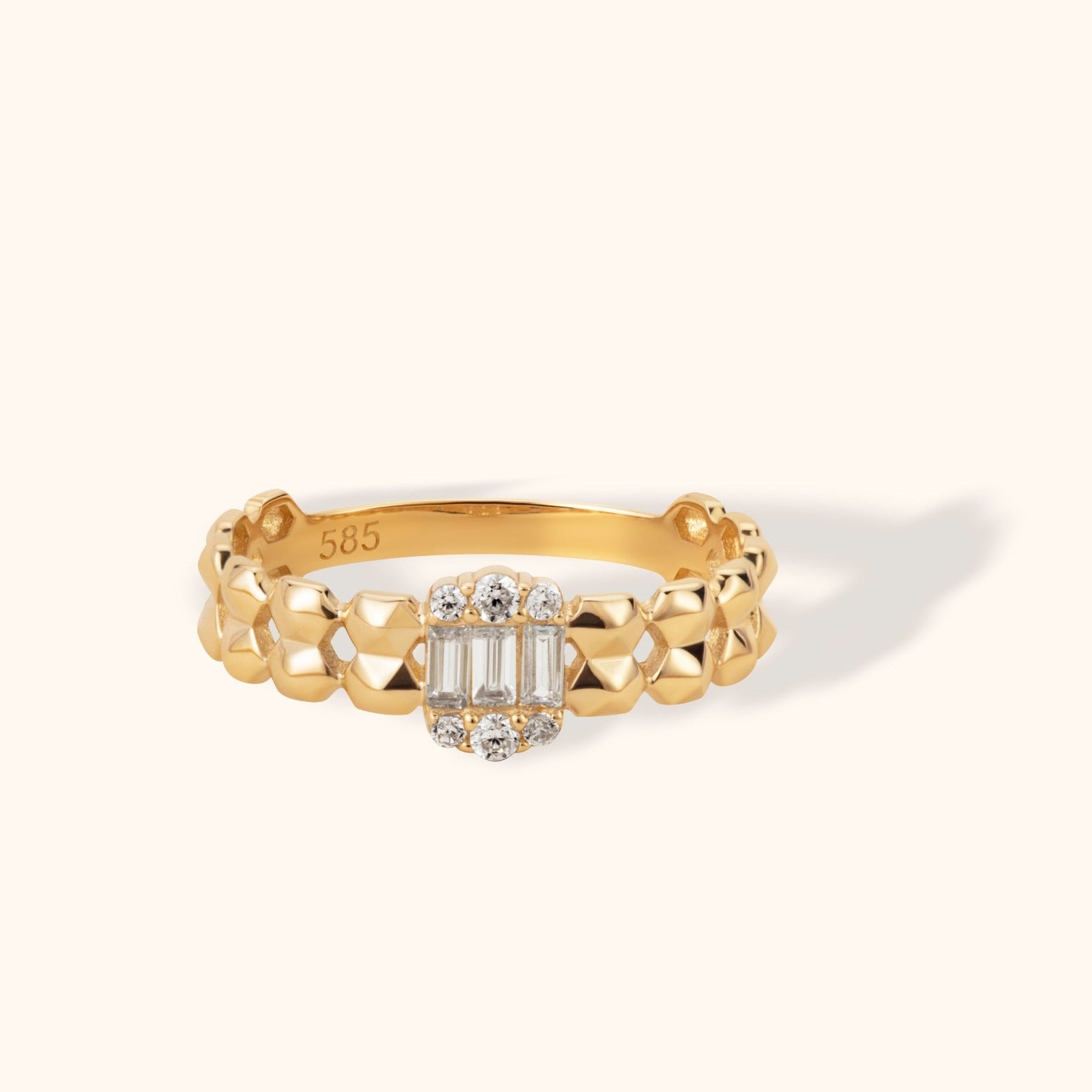 14K gold ring with faceted band and center cluster of baguette and round diamonds
