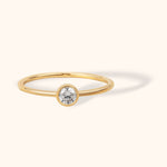 14K gold minimalist ring with round white sapphire in bezel setting