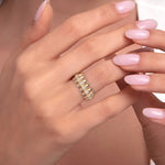 A woman's hand wearing a 14K gold spike ring with dual pavé diamond rows, styled for an edgy luxury look.