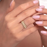 A woman's hand wearing a 14K gold spike ring with dual pavé diamond rows, styled for an edgy luxury look.