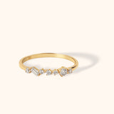 14K gold ring with asymmetrical round and baguette-cut diamonds on slim band