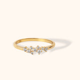 14K gold ring with a scattered diamond cluster design featuring round-cut diamonds in different sizes, celestial-inspired band