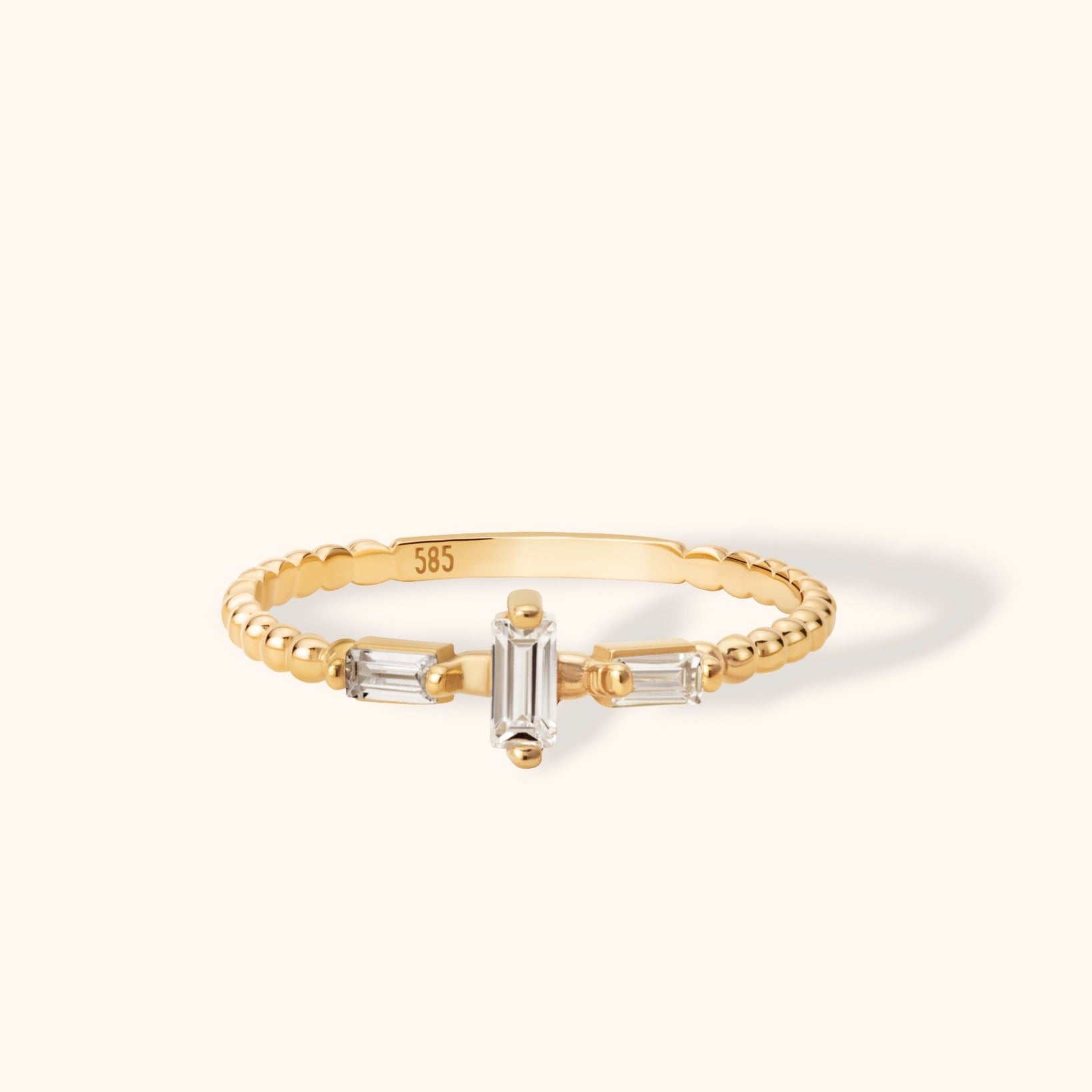 14K gold ring with beaded band and three vertical-set baguette-cut white stones
