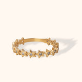 14K gold eternity band with star-shaped design and small round diamonds