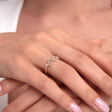Close-up shot of a zigzag 14K gold ring with cubic zirconia on a woman's finger