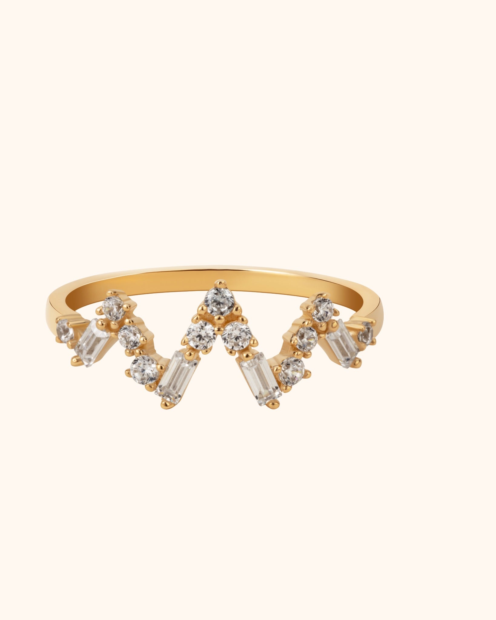 14K gold chevron ring featuring round and baguette-cut diamonds in a crown-like design