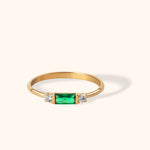 14K gold ring with baguette-cut green emerald and side diamonds