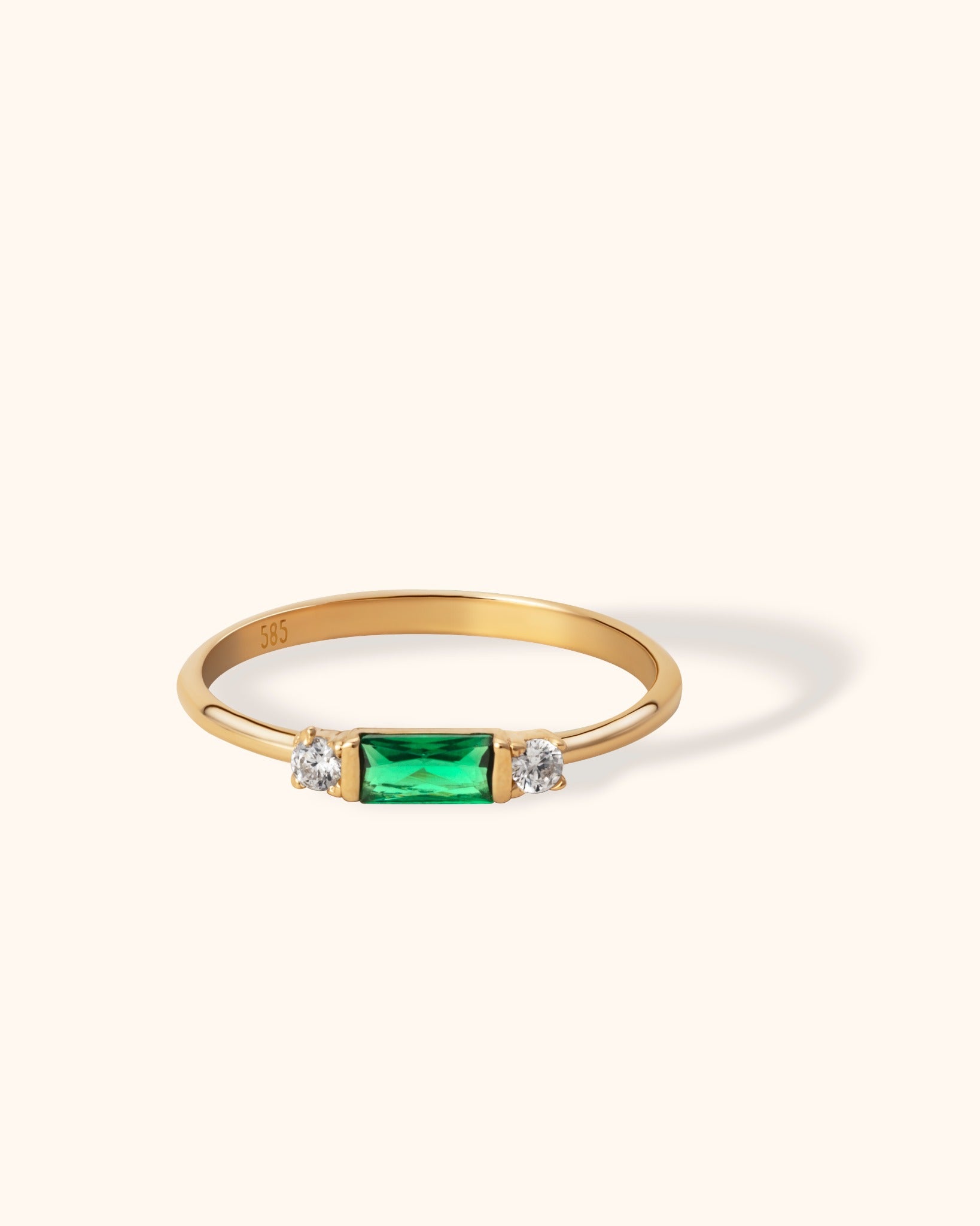 14K gold ring with baguette-cut green emerald and side diamonds
