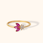 14K gold ring with marquise-cut ruby petals and a central white zirconia flower design