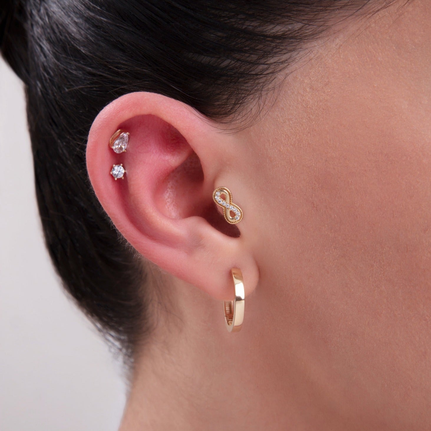 Infinity symbol tragus stud in gold with micro cubic zirconia – delicate cartilage piercing jewelry