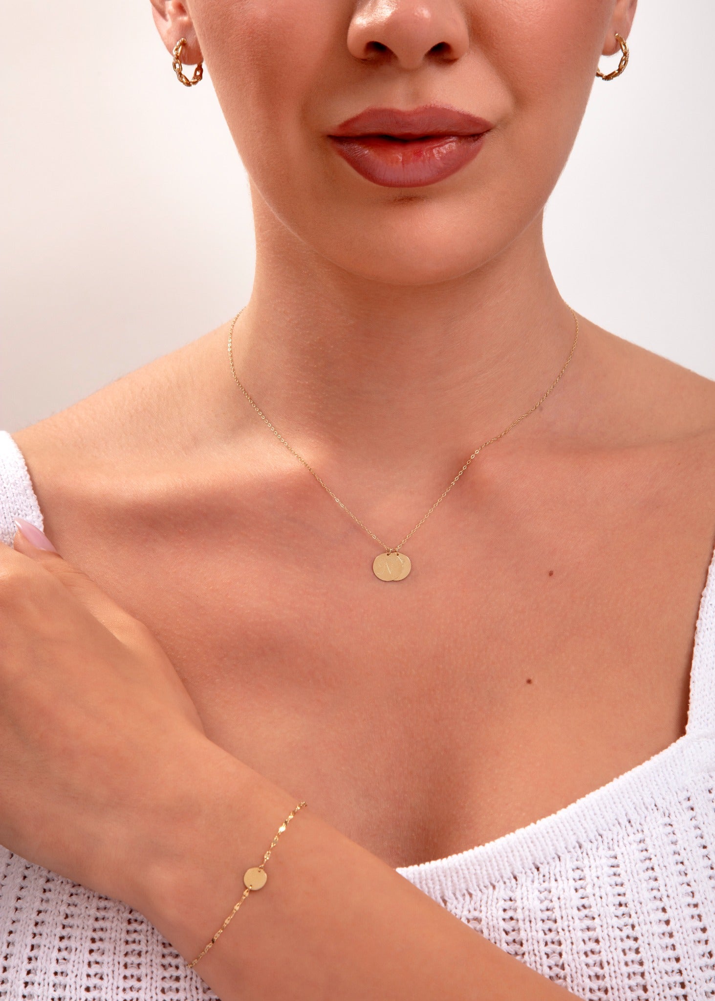 model showing complete gold set – necklace, bracelet, and hoops

