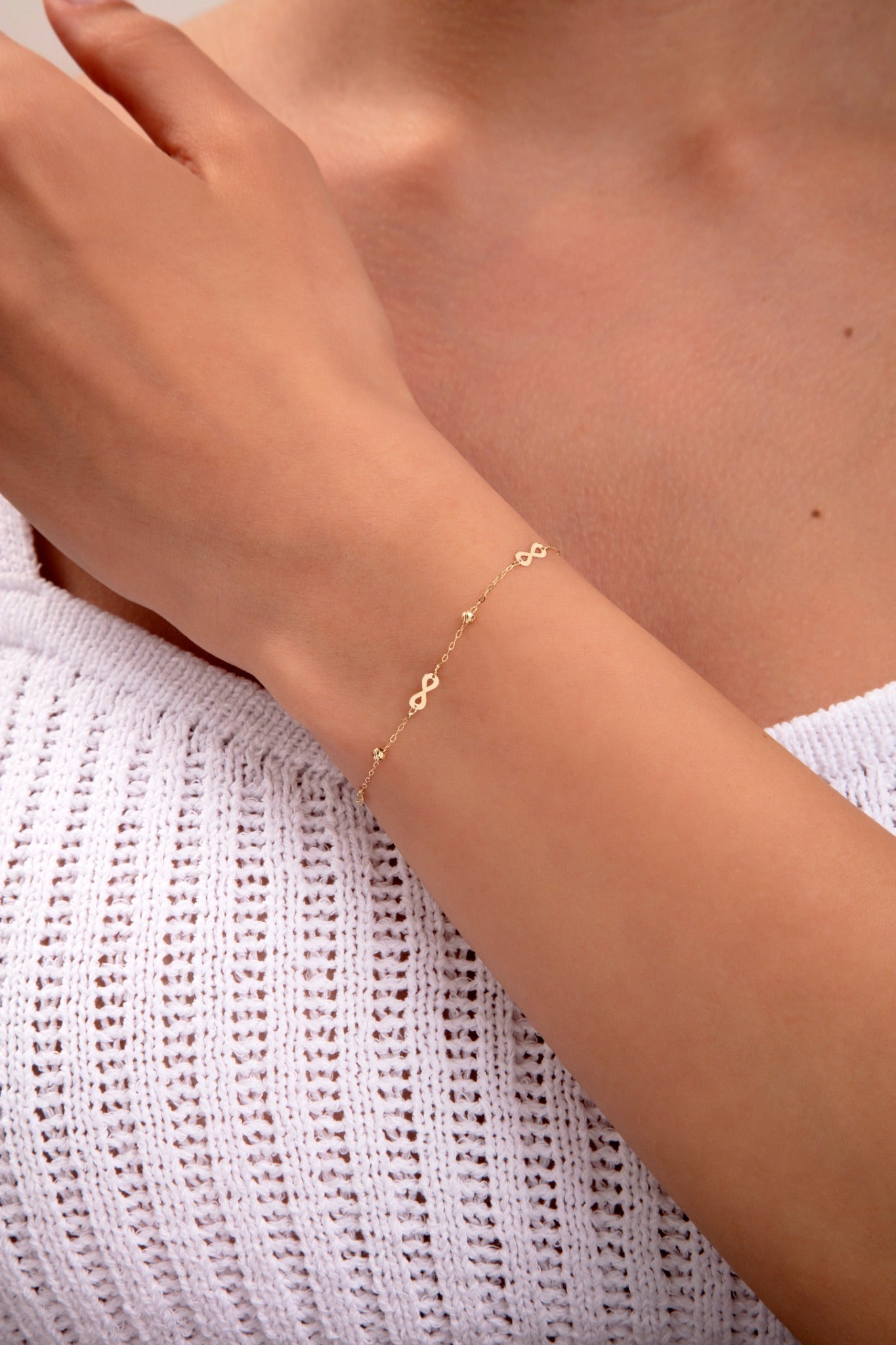 delicate gold plated bracelet with small infinity charms

