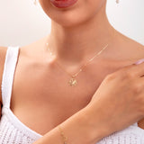 Model wearing a 14K gold plated lotus jewelry set including necklace, bracelet with crystals, and lotus threader earrings

