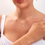 Model wearing a 14K gold plated lotus jewelry set including necklace, bracelet with crystals, and lotus threader earrings

