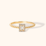 14K gold beaded ring with baguette-cut center stone and diamond halo