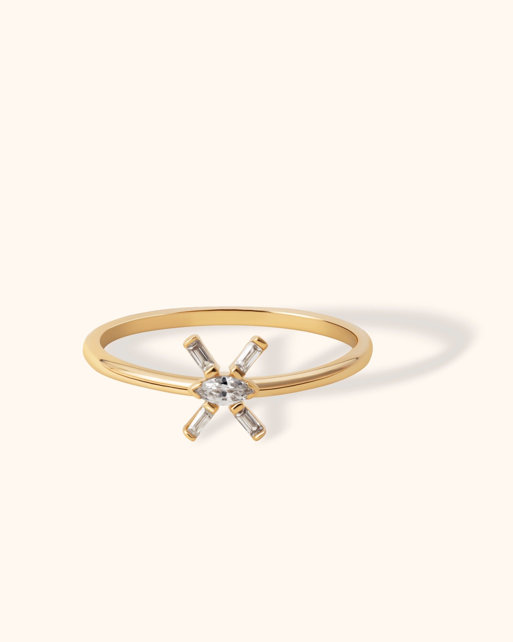 14K gold ring with marquise-cut center and baguette zirconia in a starburst design