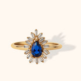 14K gold ring with pear-shaped blue sapphire and surrounding baguette diamonds