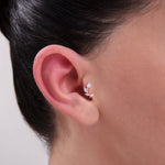 Model wearing a 14K Gold Leaf-Inspired CZ Cartilage Stud – A delicate three-marquise stone earring mimicking a leafy branch, ideal for conch, tragus, or helix piercings in a nature-inspired ear stack.