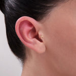 Model wearing a 14K Gold Pisces Symbol Tragus Stud – Minimalist zodiac-inspired cartilage piercing featuring the astrological Pisces sign, perfect for tragus or helix placements