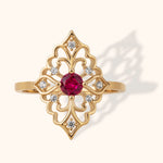 Intricate filigree ring in 14K gold featuring a round ruby center and surrounding diamonds