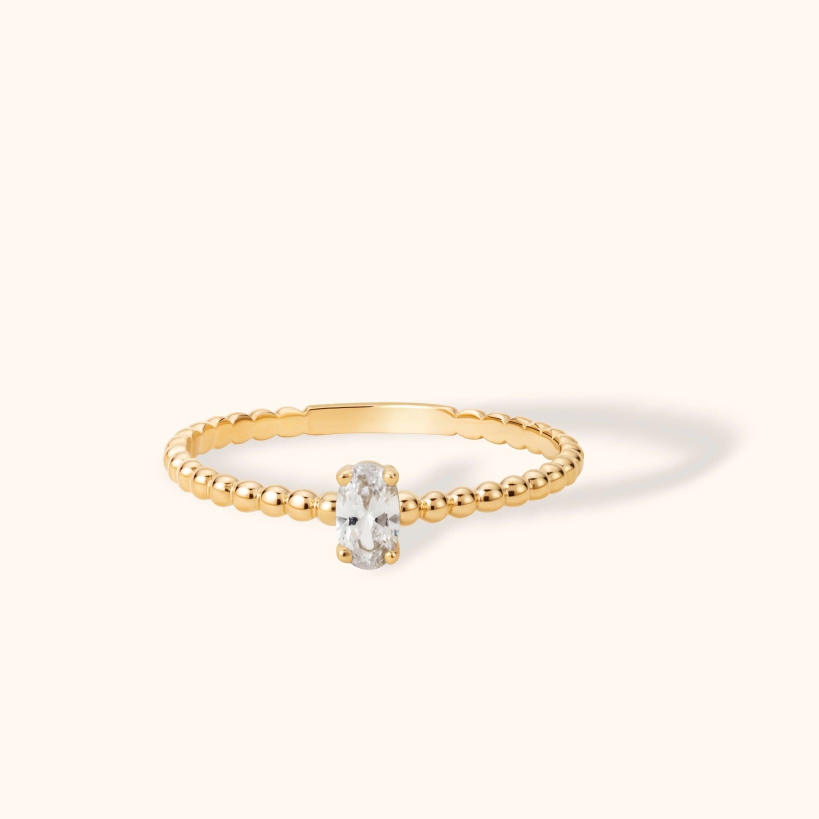 14K gold beaded band ring with oval solitaire diamond