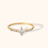 14K gold ring with princess-cut center stone and diamond accents