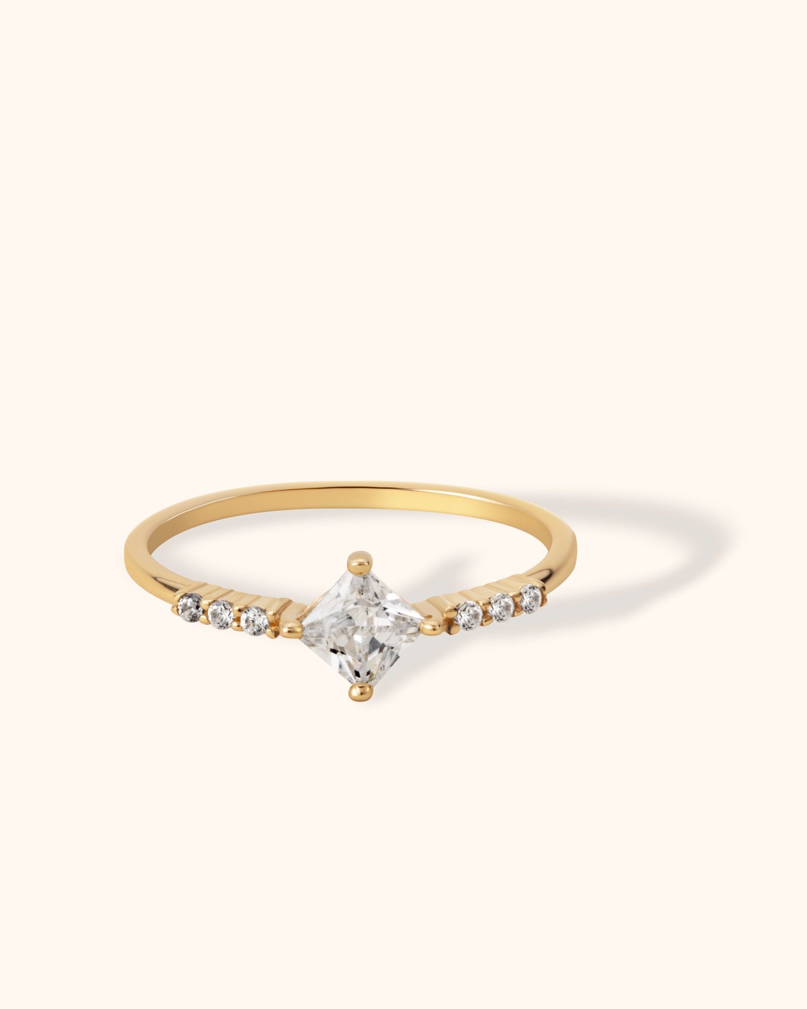 14K gold ring with princess-cut center stone and diamond accents