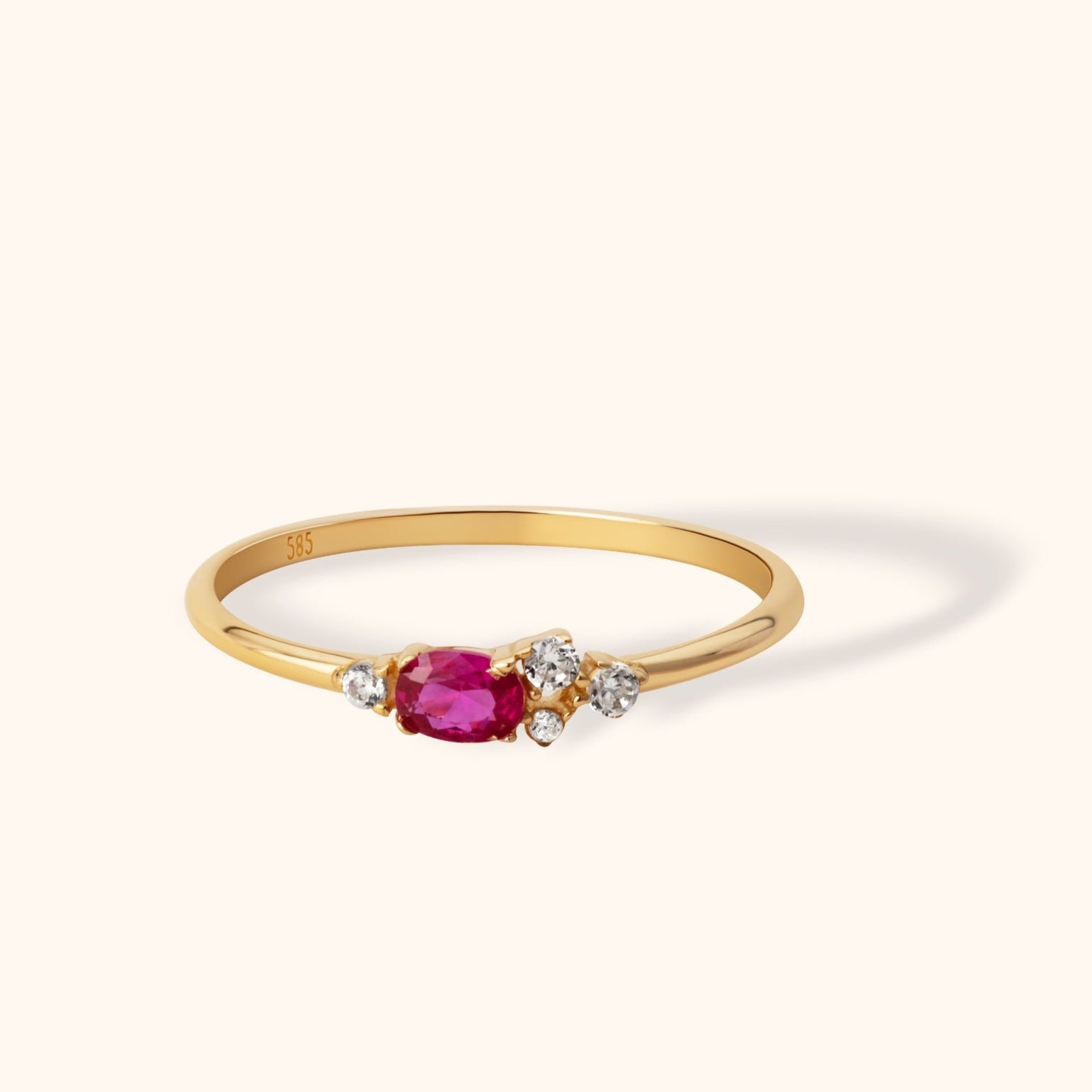 Elegant 14K yellow gold ring with oval-cut ruby center stone and clustered white diamond accents