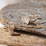Set of three 14K gold tragus studs featuring a marquise-cut triple CZ cluster, a pavé horned shield stud, and a four-stone CZ cluster – Dainty cartilage earrings perfect for stacking in tragus, helix, or conch piercings