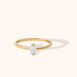 14K gold ring with vertically set baguette-cut white gemstone in minimalist design
