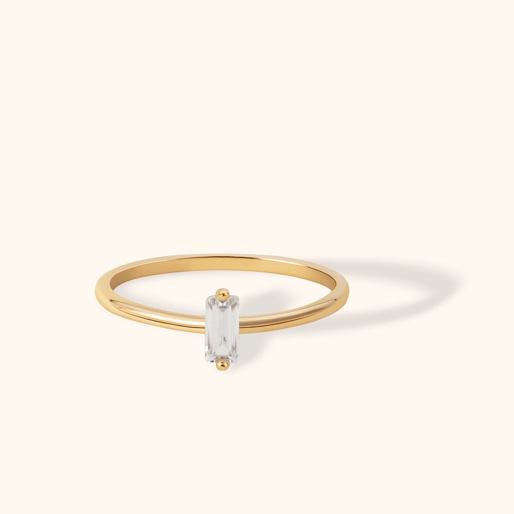 14K gold ring with vertically set baguette-cut white gemstone in minimalist design